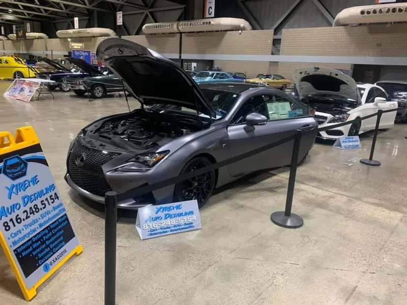 A freshly detailed coupe shown with Xtreme Auto Detailing signage
