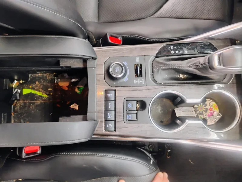 Gray vehicle interior - center console, before deep-clean