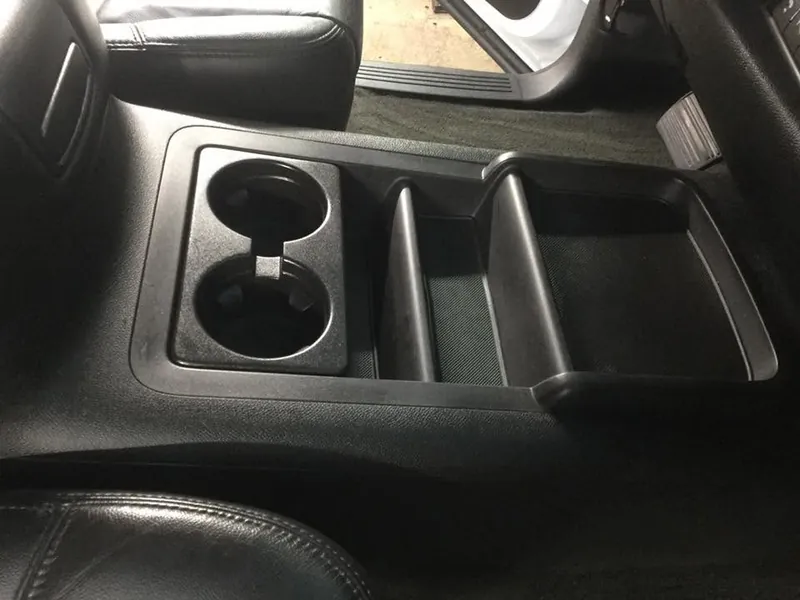 Black pickup-truck interior - deep-clean detail (center-console cup holders)