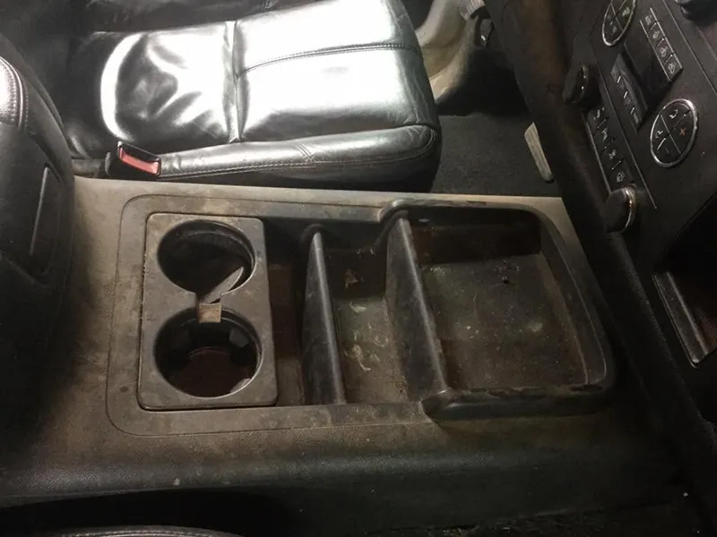 Black pickup-truck interior - deep-clean detail (center-console cup holders)